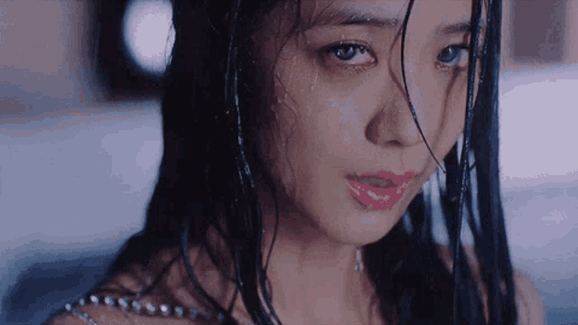 a close up of a woman 's face with water coming out of her eyes