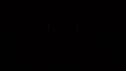 a virtual reality headset and two xbox controllers on a dark background
