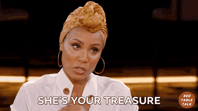 a woman says she 's your treasure while wearing a turban and earrings