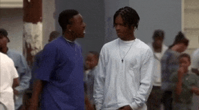 two men are standing next to each other and talking in a crowd .