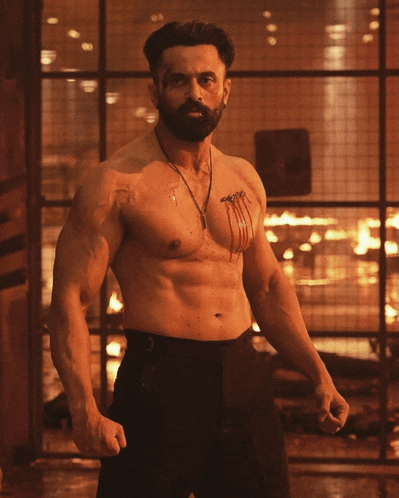 a shirtless man with blood on his chest