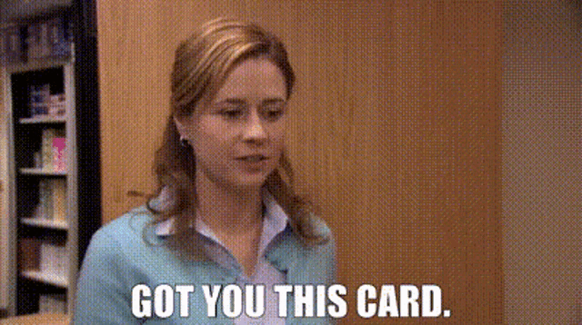 a woman is standing in a room and says `` got you this card ''