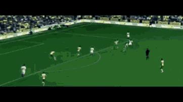 a soccer game is being played in a stadium with yellow and white jerseys