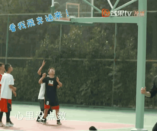 a group of young men are playing basketball on a court with the number 0 on their jersey