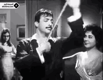 a black and white photo of a man and a woman dancing .