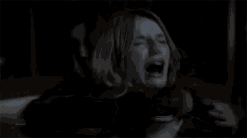 a woman is screaming with her mouth open