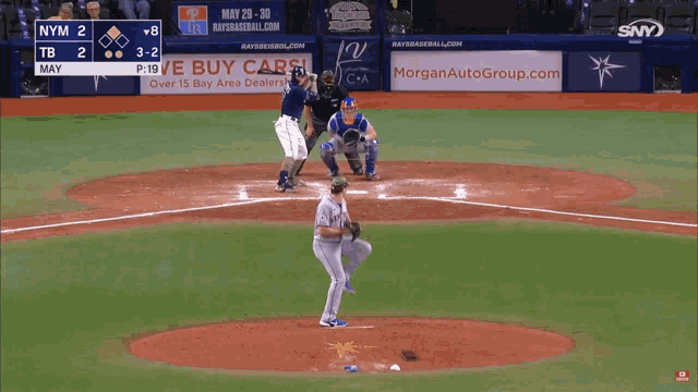a baseball game is being played with a morganautogroup.com ad in the outfield