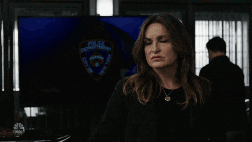 a woman in front of a police department sign