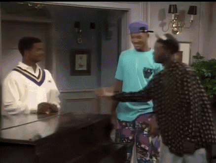 a group of men are standing around a piano in a room .