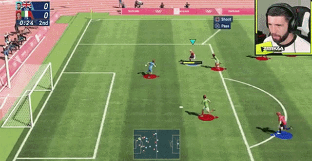 a soccer game is being played on a video game with a man wearing headphones in the background .