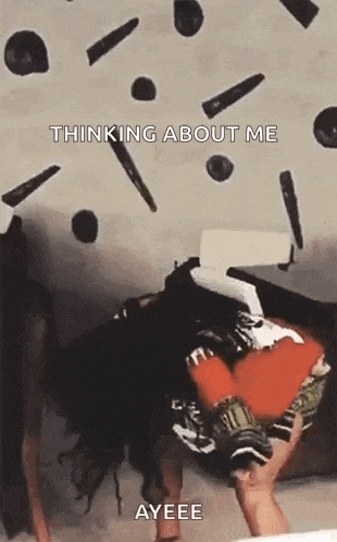 a woman is holding a box in her hands while a bunch of objects are falling on her .