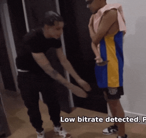 a man is standing next to another man with the words low bitrate detected