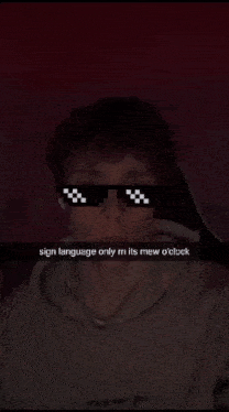 a man wearing sunglasses says sign language only m its mew o clock