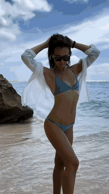 a woman in a bikini is standing in the water