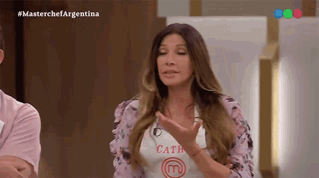 a woman wearing a white apron that says cath