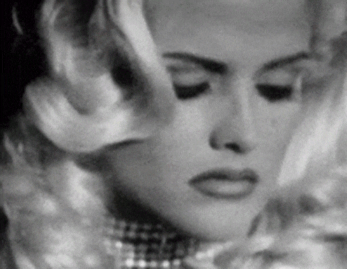 a close up of a woman 's face with her eyes closed .
