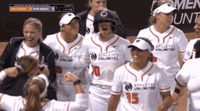 a group of athletes unlimited softball players are celebrating