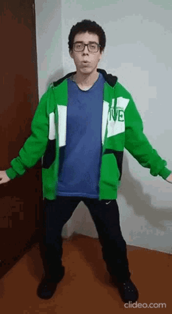 a young man wearing a green jacket that says ive