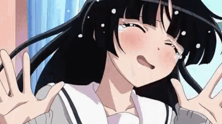 a girl with black hair and white dots on her face is crying and making a face .
