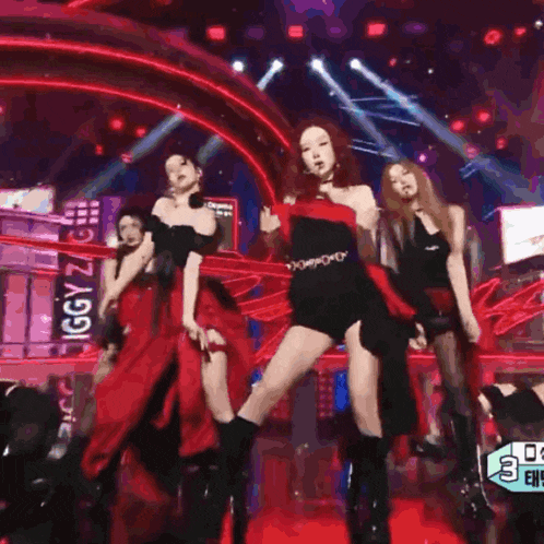 a group of women are dancing on a stage in front of a sign that says ' i drama ' on it