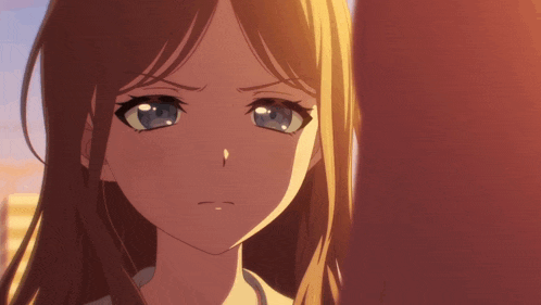 a close up of a girl 's face with a sad look on her face
