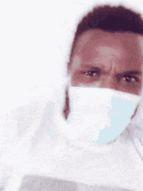 a blurry picture of a man wearing a mask on his face