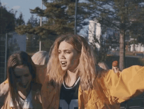 a girl wearing a yellow jacket and a jersey that says ' nf ' on it