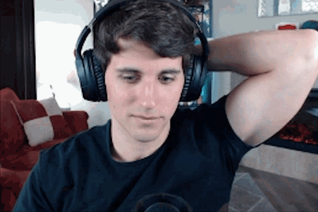 a man wearing headphones looks down at something