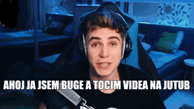 a young man wearing headphones and a black shirt says ahoj ja jsem buge a tocim videa na jutub