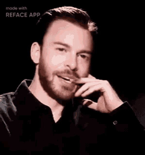 a close up of a man with a beard making a face with his hand .