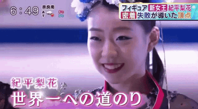 a woman with a flower crown on her head is smiling on a television screen