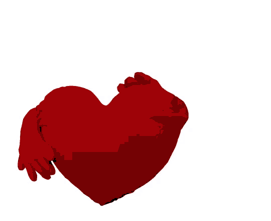 a red heart shaped pillow with a hand reaching out