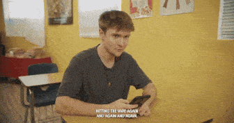a man sits at a desk with a cell phone and says hitting the vape again
