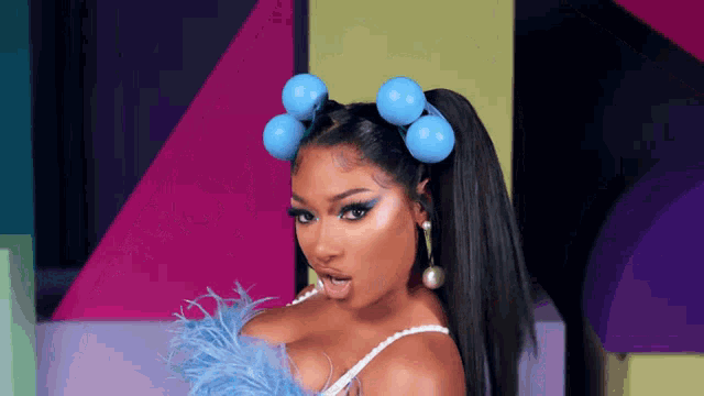 a woman with a ponytail and blue hair rollers on her head