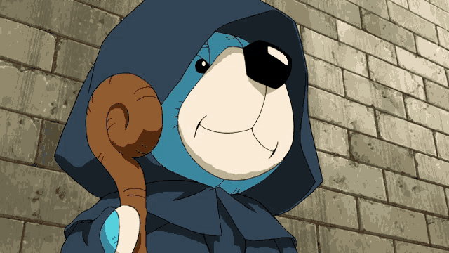 a teddy bear wearing a hood and holding a cane is standing in front of a brick wall