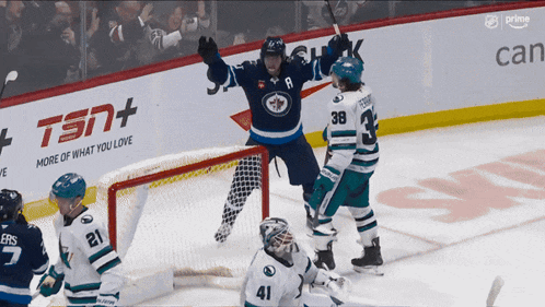 a hockey game is being played in front of an ad for tsn