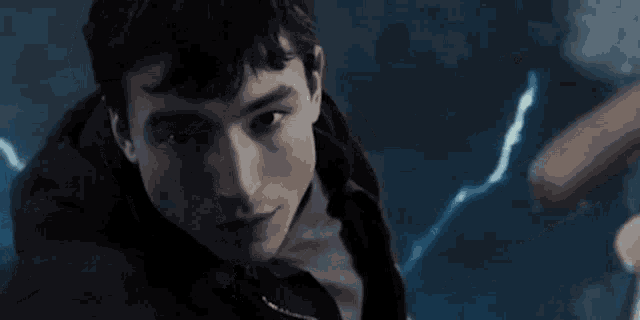 a close up of a young man holding a bat in his hand .