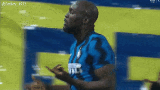 a soccer player wearing a blue and black jersey with the letters v.s. on it