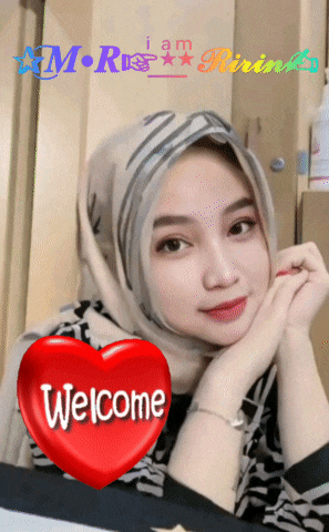 a woman wearing a hijab with a red heart that says welcome on it