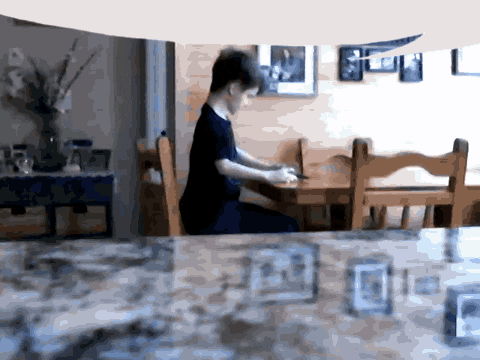 a blurry picture of a person sitting at a desk