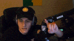 a young man wearing headphones and a rode microphone