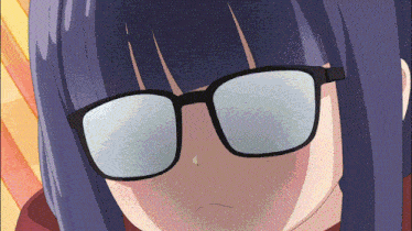 a close up of a girl wearing glasses with a slight smile on her face