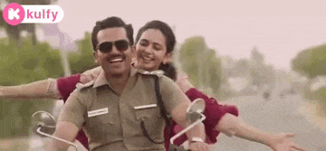 a man in a police uniform is riding a motorcycle with a woman behind him .