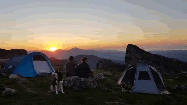 a group of people sitting in front of a tent that says deuter