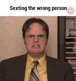 a man in a suit and tie is making an angry face .