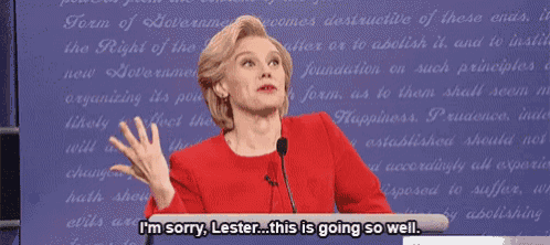 a woman stands at a podium and says i 'm sorry lester