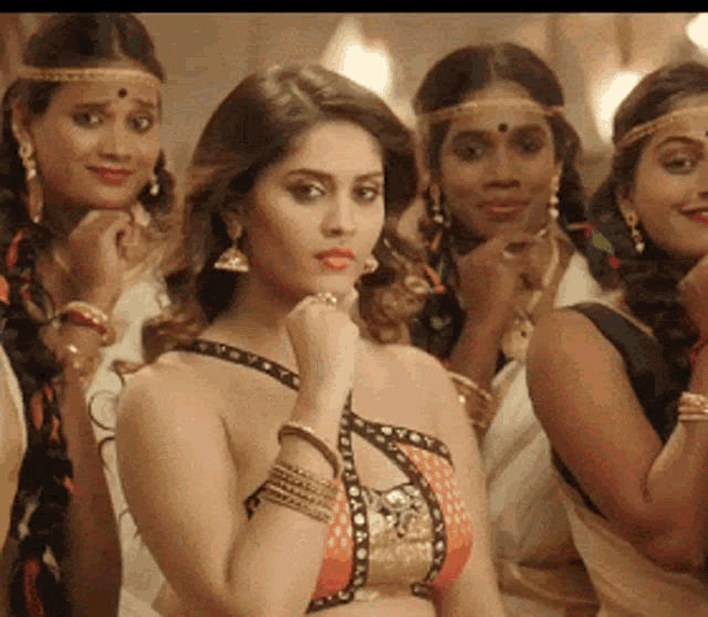 a group of women are posing for a picture and one of them is wearing a braided headband