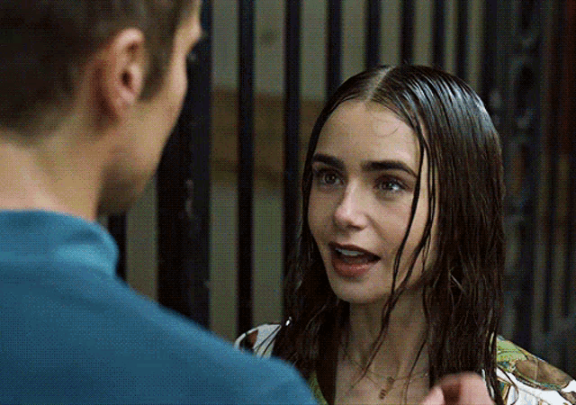 a woman talking to a man with wet hair