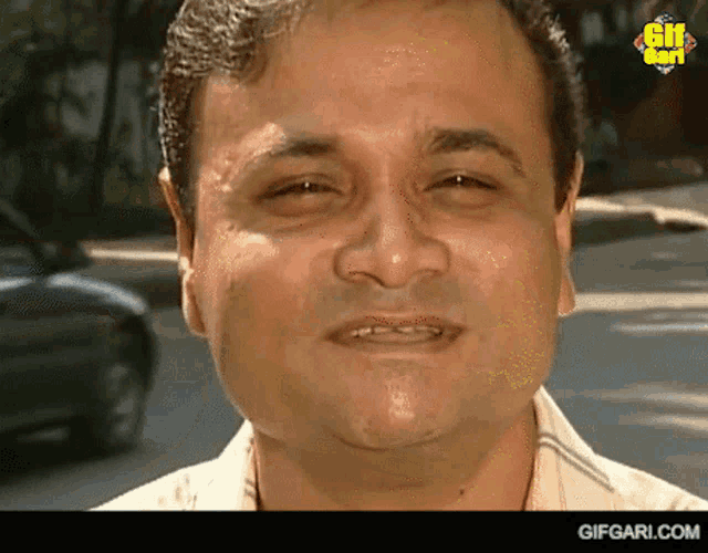a close up of a man 's face with the website gifgari.com visible