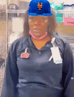 a woman wearing a blue hat with the letter m on it .
